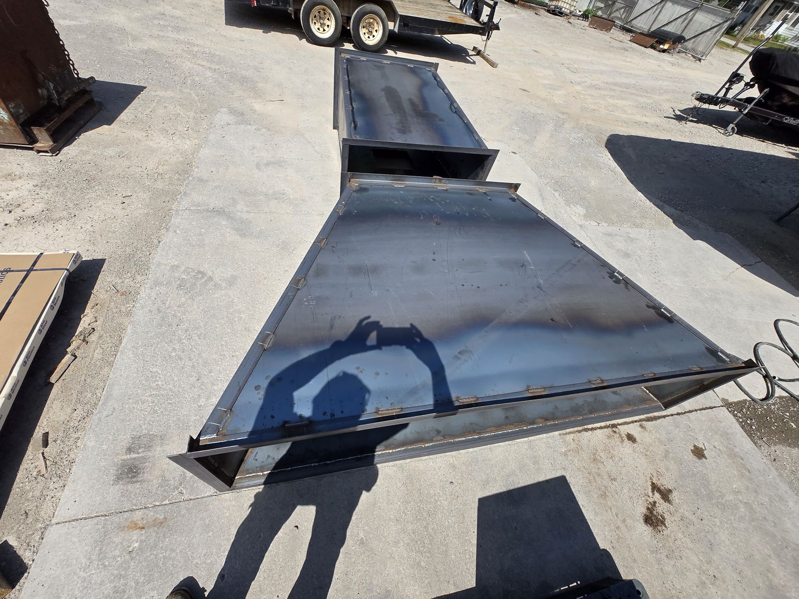 Two large rectangular steel duct sections with flanged ends.