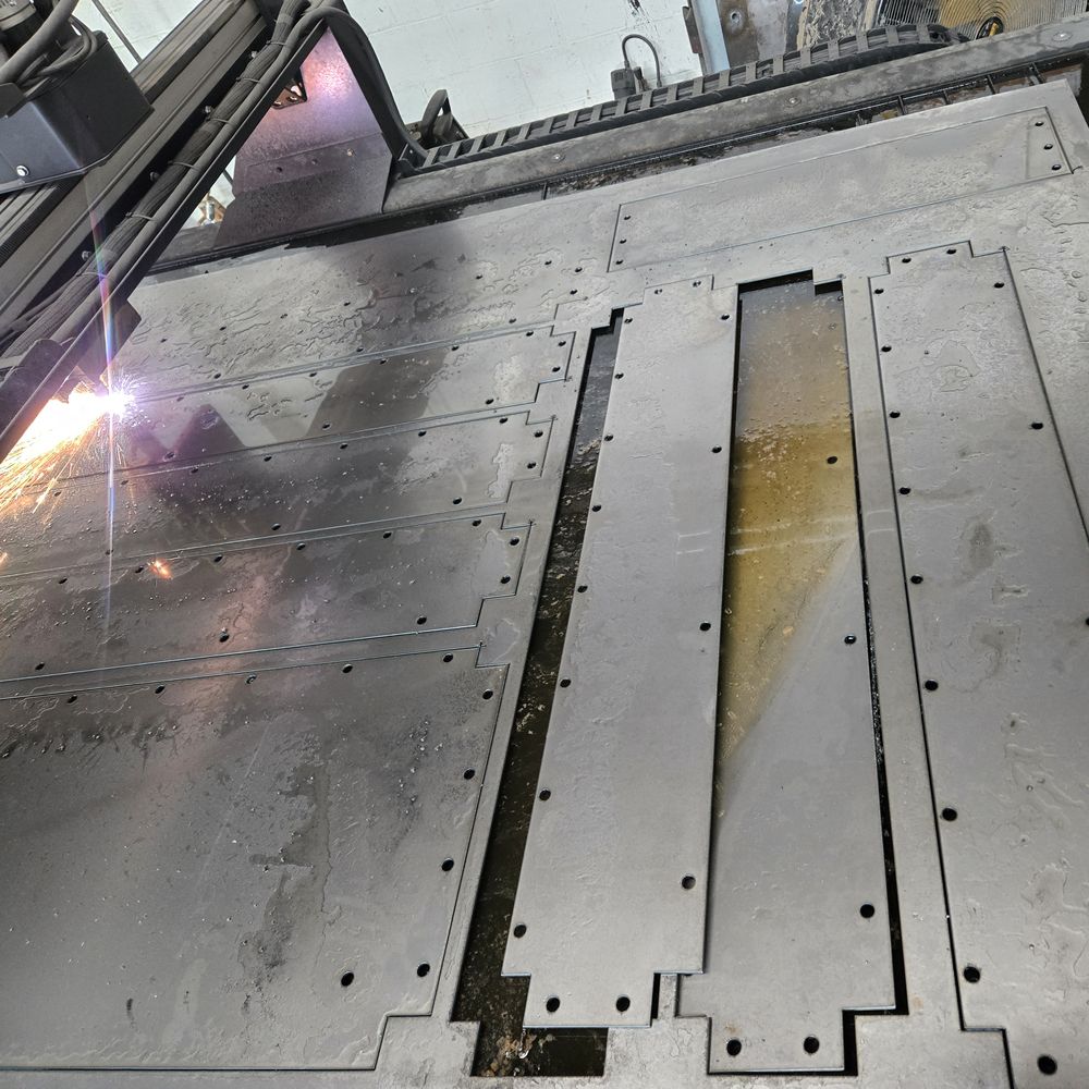 The plasma torch cutting steel plate, sparks flying.