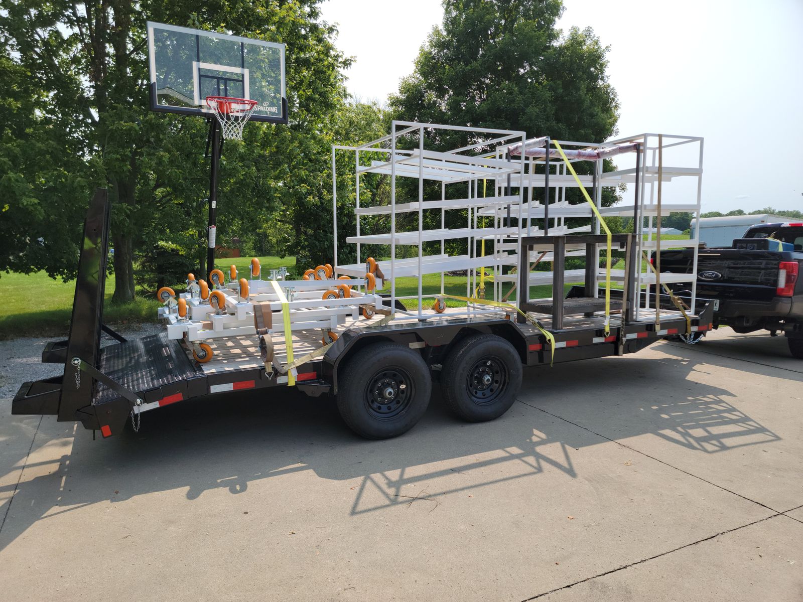 Finished racks and carts strapped to a trailer for delivery.
